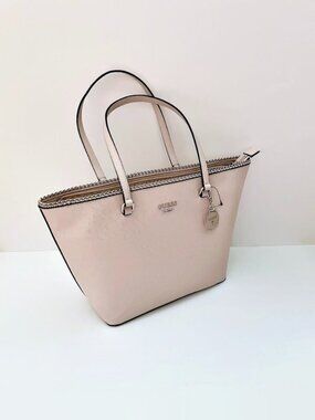 GUESS logos cover the faux-leather foundation tote